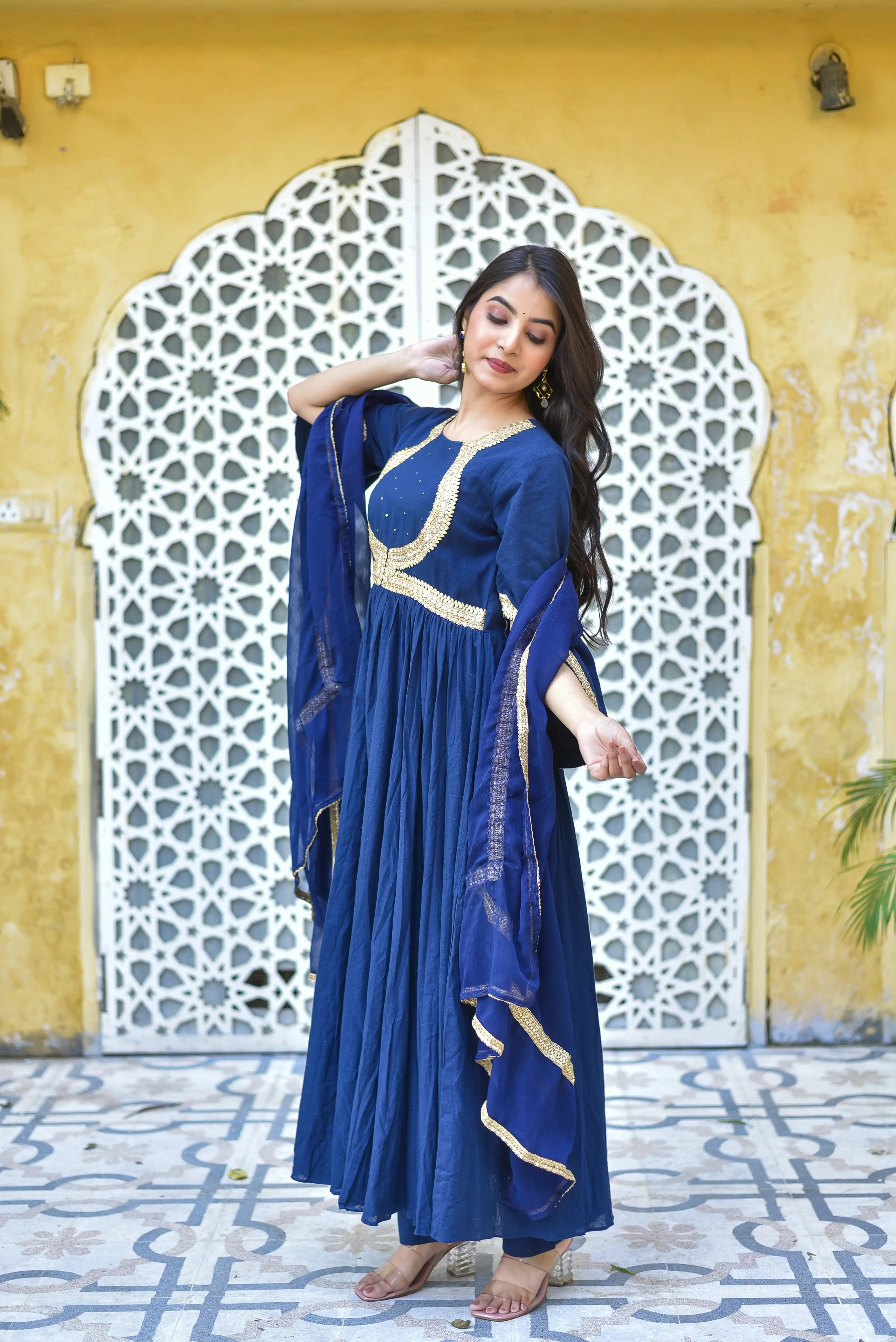 The Blue Mastani Anarkali Set is a stunning and elegant ensemble that exudes regality and sophistication. This royal blue anarkali set is inspired by the timeless beauty of Mastani, a character from Indian history known for her grace and poise.

The set features a dramatic floor-length anarkali top with a flowy silhouette, crafted from a luxurious fabric that drapes elegantly on the body. The rich sapphire hue of the top is accentuated by intricate gold embroidery, adding a touch of opulence and refinement.