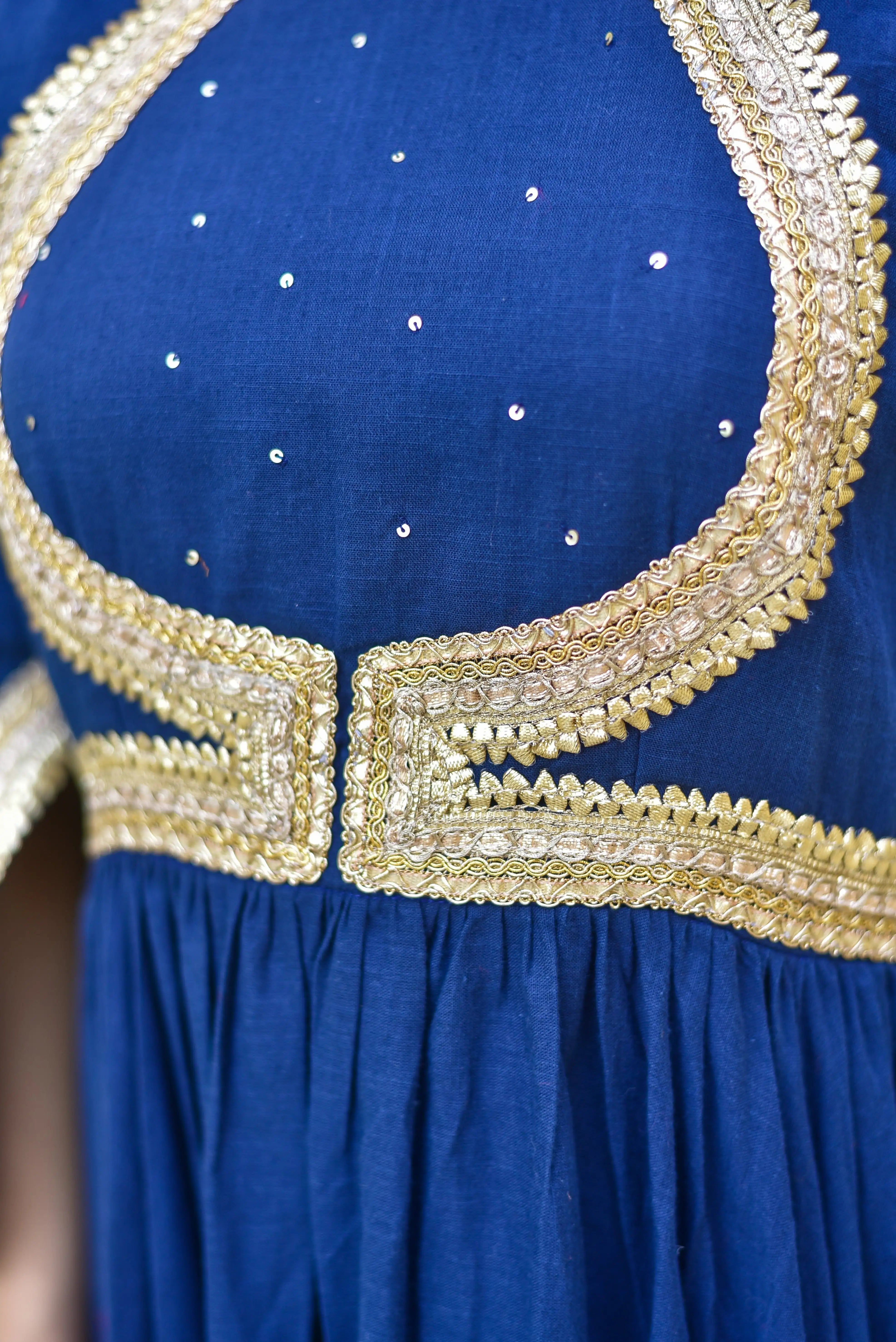 The blue Mastani Anarkali Set exudes regal elegance, inspired by the timeless grace of royalty. This stunning ensemble features a dramatic floor-length silhouette that flows like poetry in motion, commanding attention at every celebration with its rich sapphire hue. The intricate details and luxurious fabric make it a true masterpiece of Indian fashion, perfect for making a statement at any occasion.