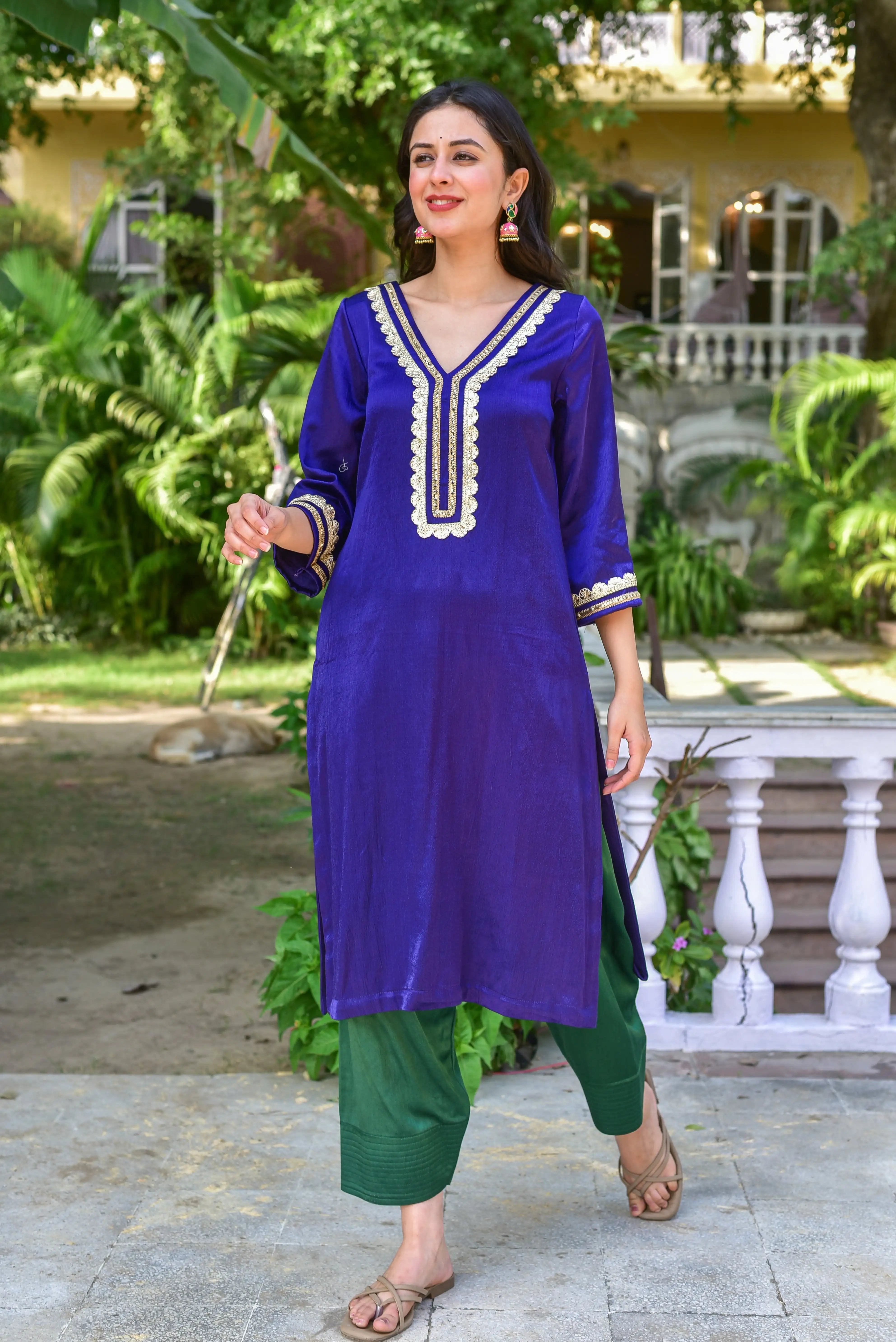 The Truffle Silk Ensemble is a stunning kurta set crafted from a luxurious silk blend, showcasing the perfect marriage of rich fabric and exquisite detailing. The deep royal blue hue evokes timeless sophistication, while intricate gold embroidery adds a touch of elegance to the V-neckline and cuffs. The three-quarter sleeves and straight cut of the kurta provide a comfortable and stylish fit, while the matching bottom with a straight cut and elasticated waistband ensures a flattering silhouette.