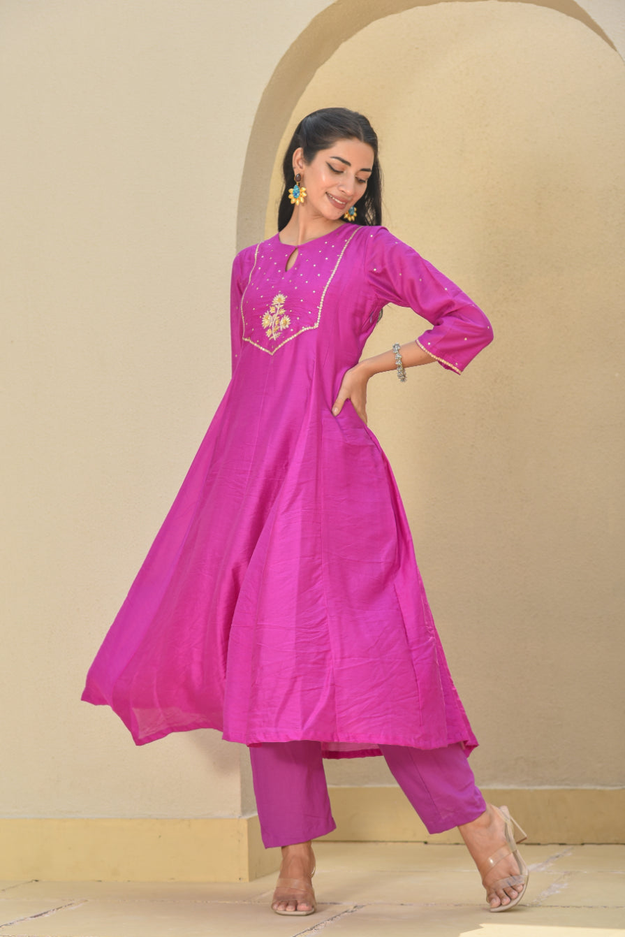 Woman wearing a pink traditional outfit with a beige background