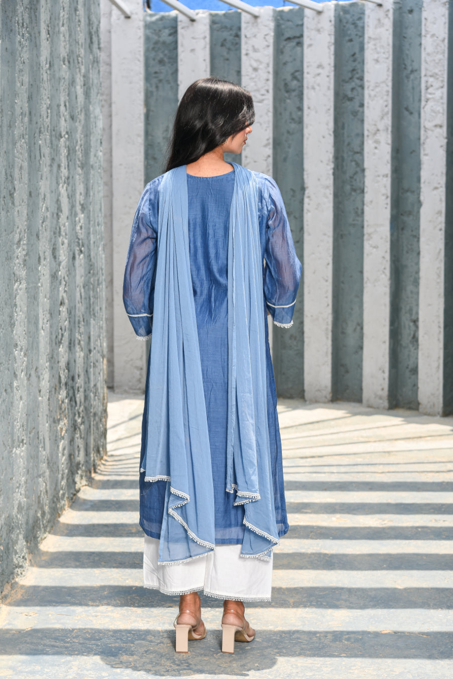 Woman wearing a blue outfit with a white background