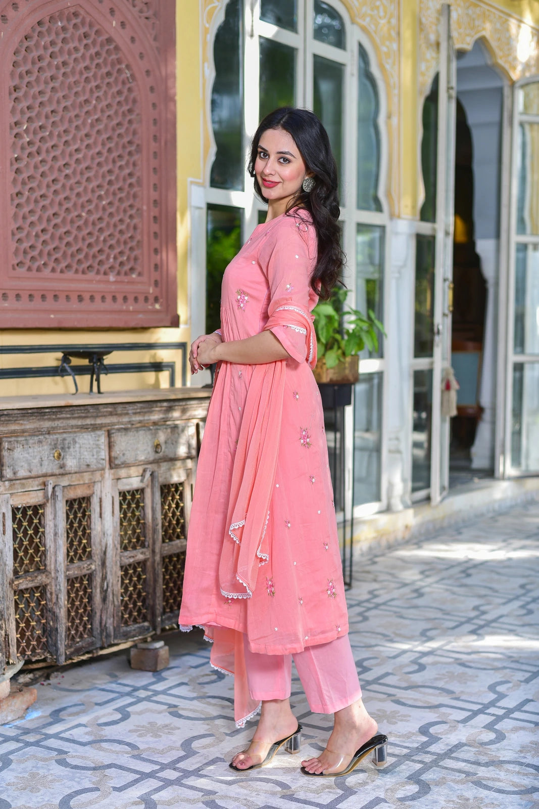 The Peach Petal Kurta Set - A stunning 3-piece ensemble that combines elegance with comfort.

This beautiful set features a gracefully flared kurta in a lovely peach hue, crafted from premium pure cotton fabric for all-day comfort. The kurta is adorned with delicate embroidery, adding a touch of sophistication to its already elegant design. Paired with matching trousers and a dupatta, this set is perfect for any occasion that calls for a stylish yet comfortable look.