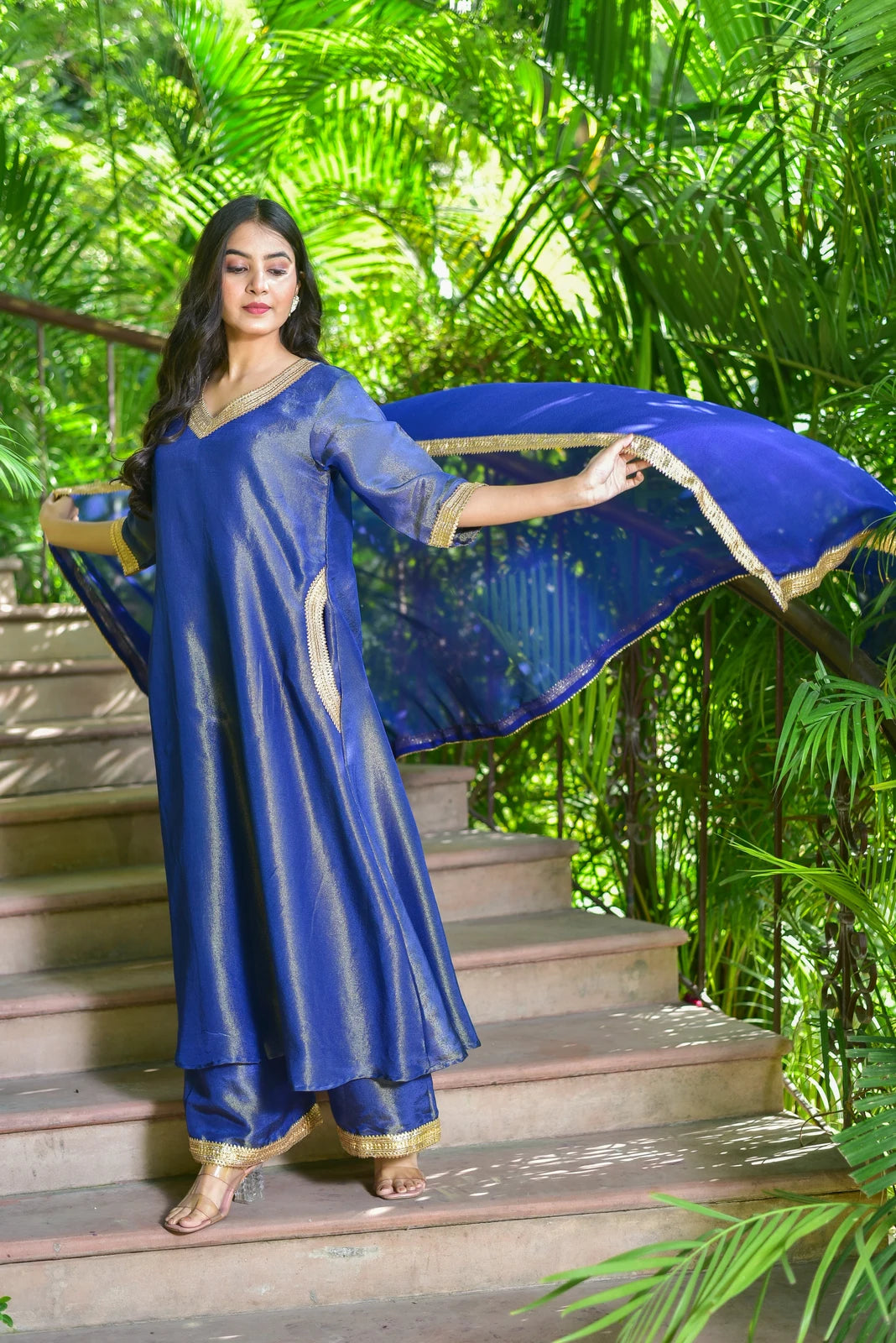 The Ocean Pearl Kurta Set is a stunning 3-piece ensemble crafted from rich zari silk fabric, featuring exquisite gold lace work that adds an extra layer of elegance to its already luxurious design. This beautiful set is perfect for festive celebrations and special occasions, where you want to make a statement with your attire. The intricate gold lace work adds a touch of sophistication and refinement, making it a must-have for anyone looking to elevate their style game.
