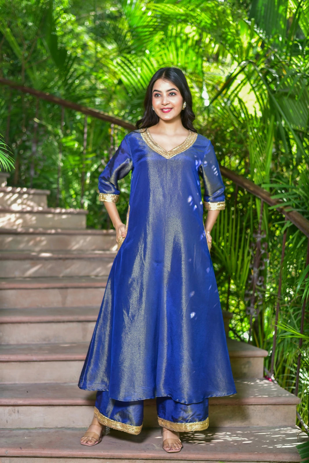 The Ocean Pearl Kurta Set is a stunning 3-piece ensemble crafted from rich zari silk fabric, adorned with exquisite gold lace work. This luxurious set features a V-neckline kurta, wide-leg palazzo pants, and a matching dupatta, perfect for festive celebrations and special occasions. The intricate gold lace work adds a touch of elegance, while the ocean-inspired color palette evokes the depth and beauty of the sea. With its comfortable fit and stylish design, this set is sure to make a statement.