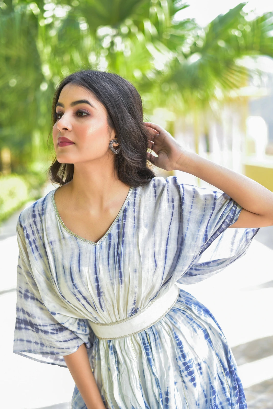 The Indigo Cloud Shibori Kaftan Set is a stunning 3-piece ensemble that exudes elegance and sophistication. This luxurious kaftan set features mesmerizing hand tie-dye shibori patterns in serene blue and white, creating a truly unique and eye-catching look. The kaftan itself is crafted from high-quality fabric, ensuring both comfort and durability, while the V-neckline and short sleeves add a touch of contemporary flair.