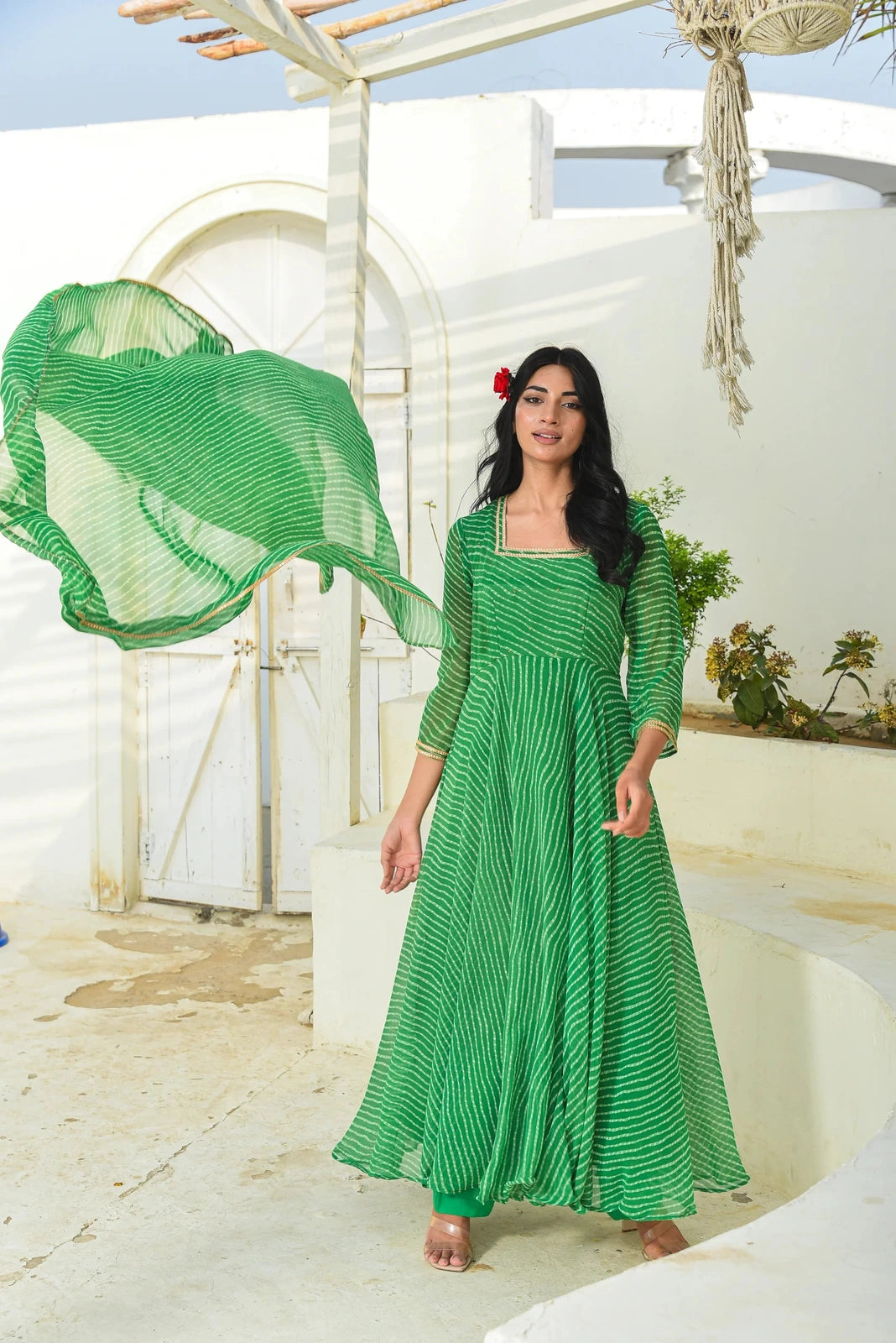 The image showcases a stunning blue set, comprising a lehenga, blouse, and dupatta, adorned with a sweetheart neckline, 3/4 sleeves, and an elegant Modhada print. The blouse features a hook placket closure, while the lehenga boasts a hook placket with zip, both finished with intricate lace detailing. This exquisite ensemble is perfect for festive occasions, exuding a sense of sophistication and style.