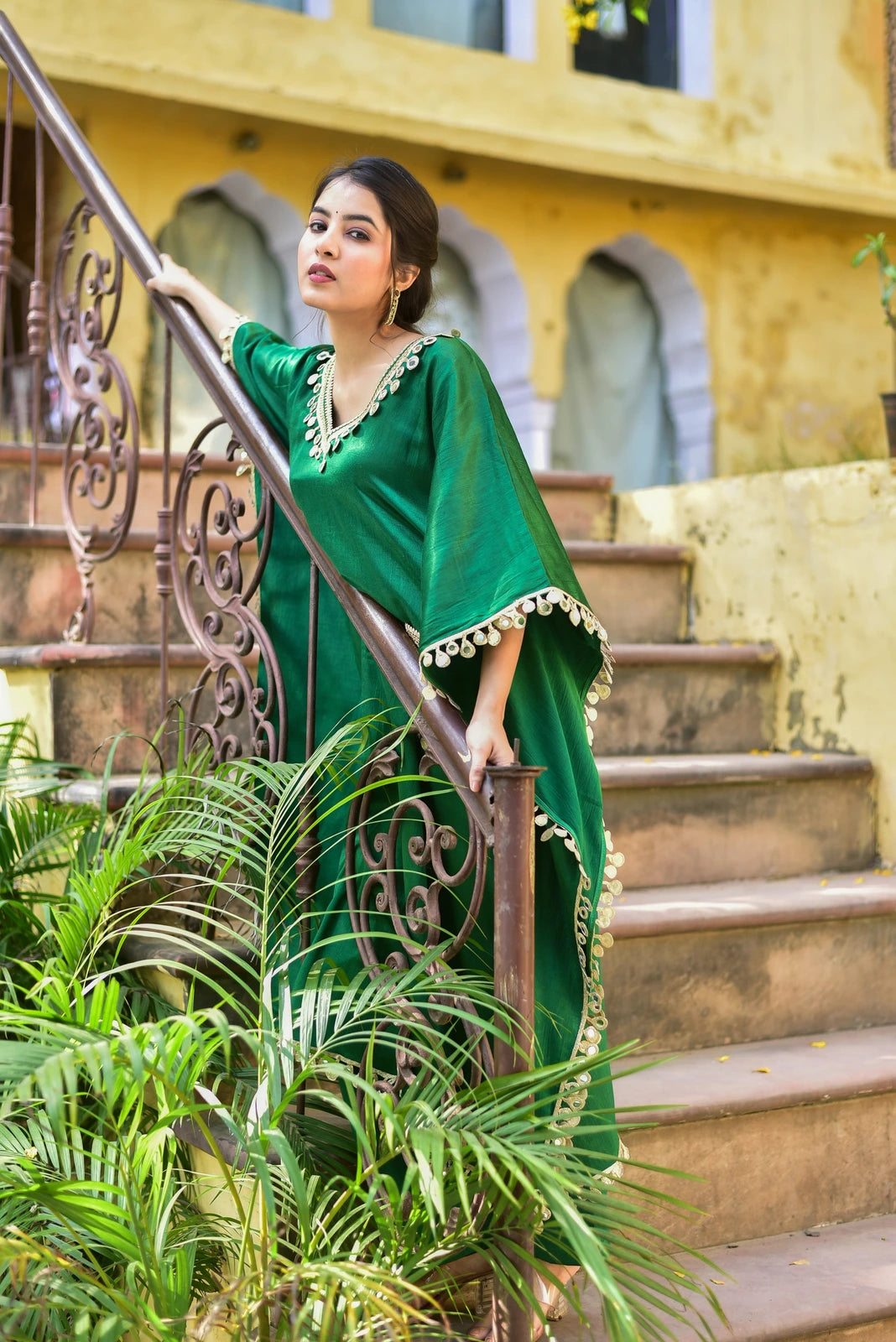 The Forest Glaze Mirror Work Set is a stunning kaftan set that exudes regal elegance and contemporary ease. Crafted from luxurious Gazzi Satin, this emerald green ensemble captures the richness of the forest with exquisite mirror work detailing that catches the eye. The kaftan's flowing design and elegant mirror work make it perfect for any occasion, from formal events to casual gatherings. With its unique blend of traditional and modern elements, this set is sure to make a statement and turn heads.