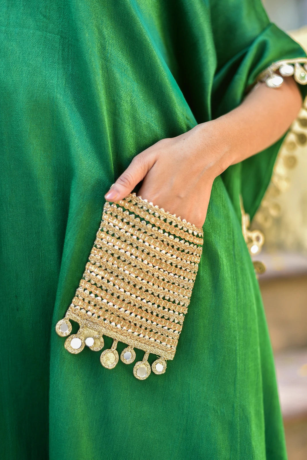 The Forest Glaze Mirror Work Set is a stunning ensemble that embodies regal elegance and contemporary ease. Crafted from luxurious Gazzi Satin, this kaftan set boasts a rich emerald hue that evokes the majesty of the forest. The exquisite mirror work detailing adds a touch of sophistication, catching the light with its intricate patterns and textures.

This elegant and trendy set is perfect for making a statement at any occasion, from formal events to casual gatherings.