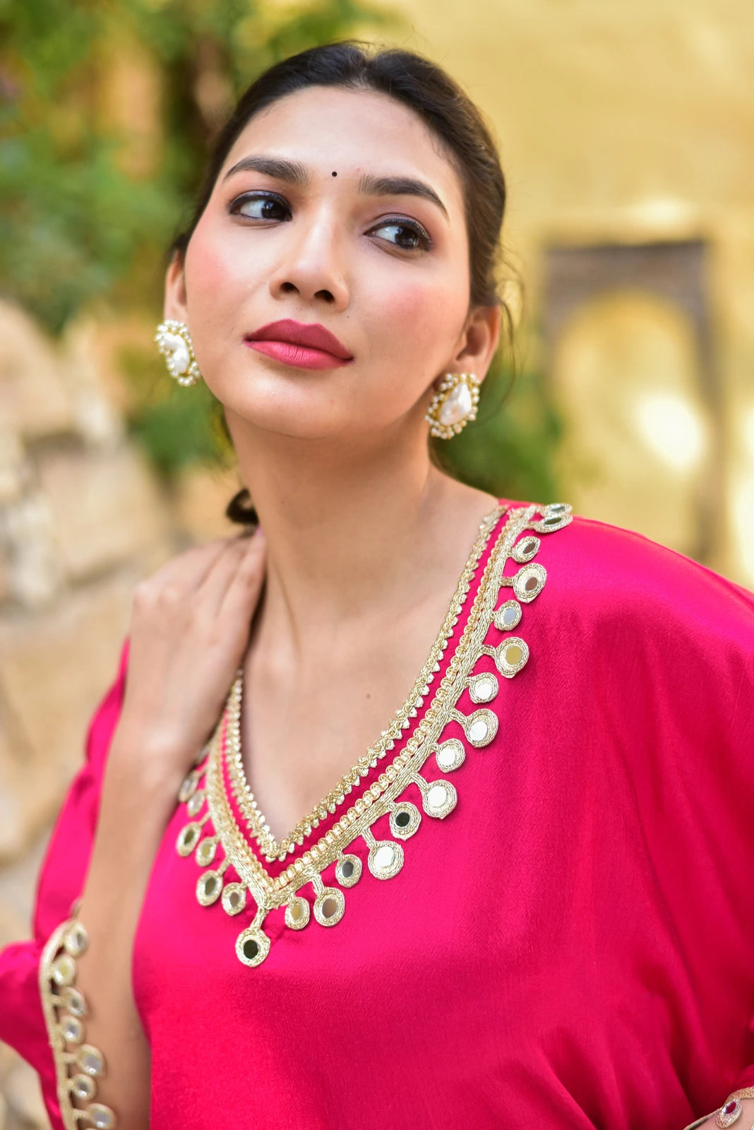 The Gulabi Glaze Mirror Work Set is a stunning ensemble that embodies regal elegance and contemporary ease. Crafted from luxurious Gazzi Satin, this kaftan set captures the richness of emerald forests with exquisite mirror work detailing that catches the eye. The set features a flowing kaftan with a relaxed fit, perfect for making a statement at any occasion. The mirror work adds a touch of sophistication and glamour, while the Gazzi Satin fabric ensures a comfortable and luxurious feel.