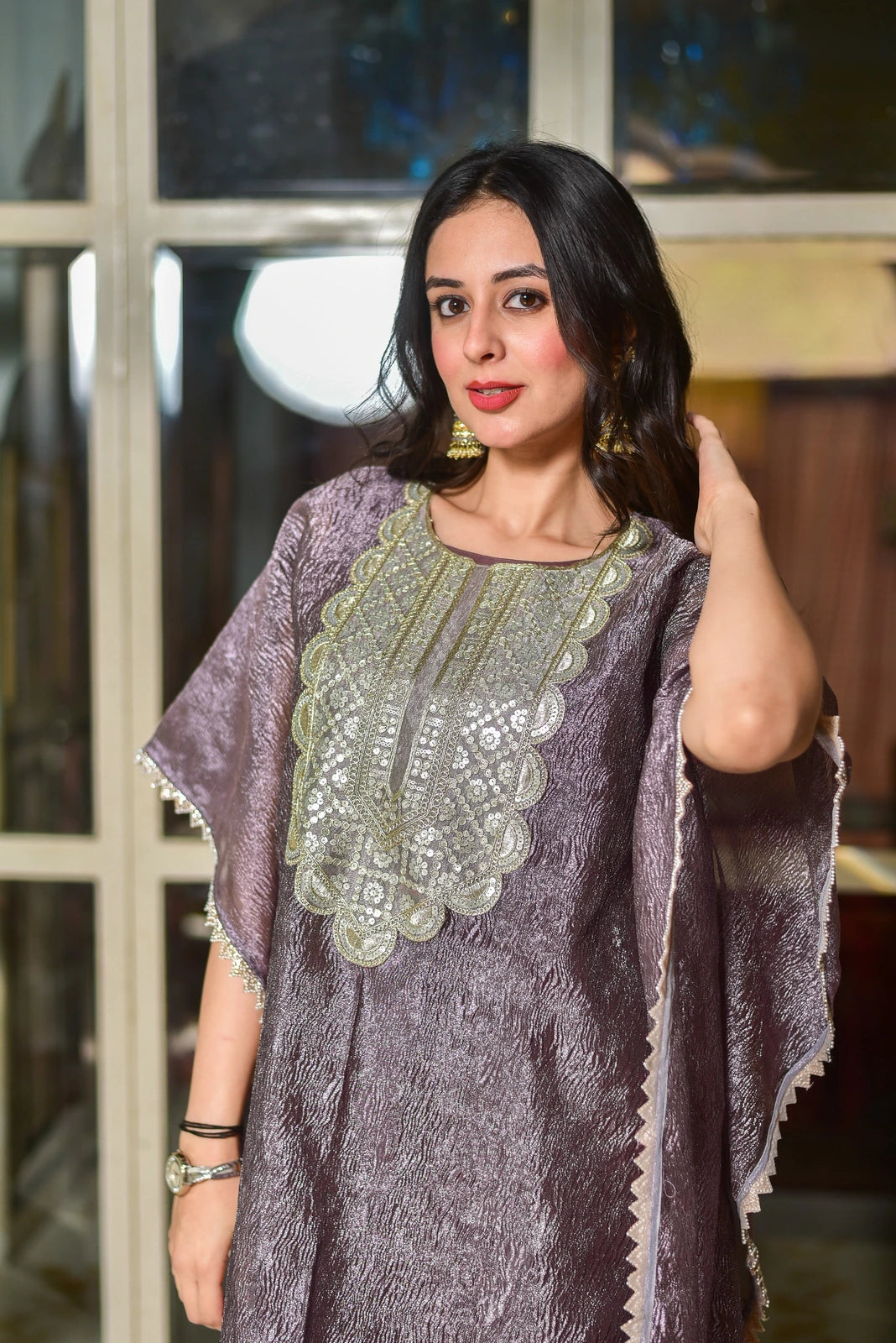 The Lavender Luxe Embroidered Kaftan Dress is a stunning piece of contemporary luxury, crafted from premium moss organza that drapes elegantly while maintaining its graceful structure. The sophisticated lavender tone exudes regal charm, making this kaftan a statement for your wardrobe. The intricate embroidery adds a touch of refinement, elevating the overall look to new heights of elegance. This kaftan is perfect for those seeking a stylish and comfortable piece that makes a lasting impression.