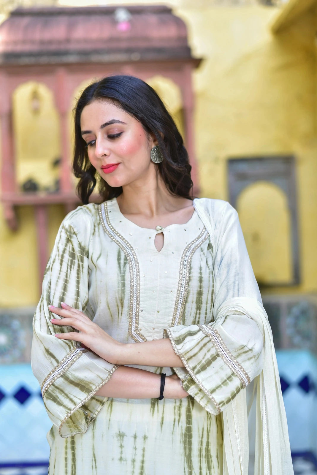 The moss green shibori straight kurta set is a stunning ensemble that seamlessly blends traditional artisanal techniques with contemporary elegance. The set comprises a kurta, pants, and a dupatta, each crafted with meticulous attention to detail.

Key Features:

 Shibori Artistry: The kurta features intricate tie-dye patterns, showcasing the traditional shibori technique that adds a unique and eye-catching element to the overall design.