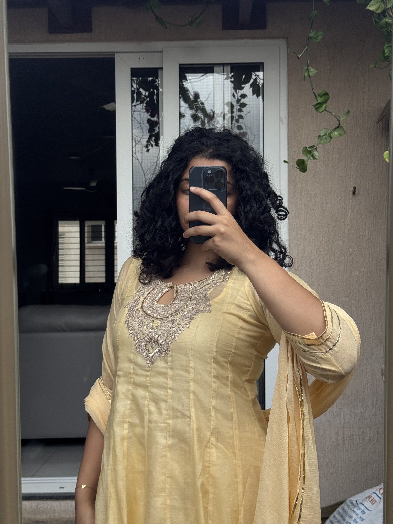 Saroj Jain Pastel Sunshine Yellow Lucknowi Chikankari Anarkali Gown side angle view.