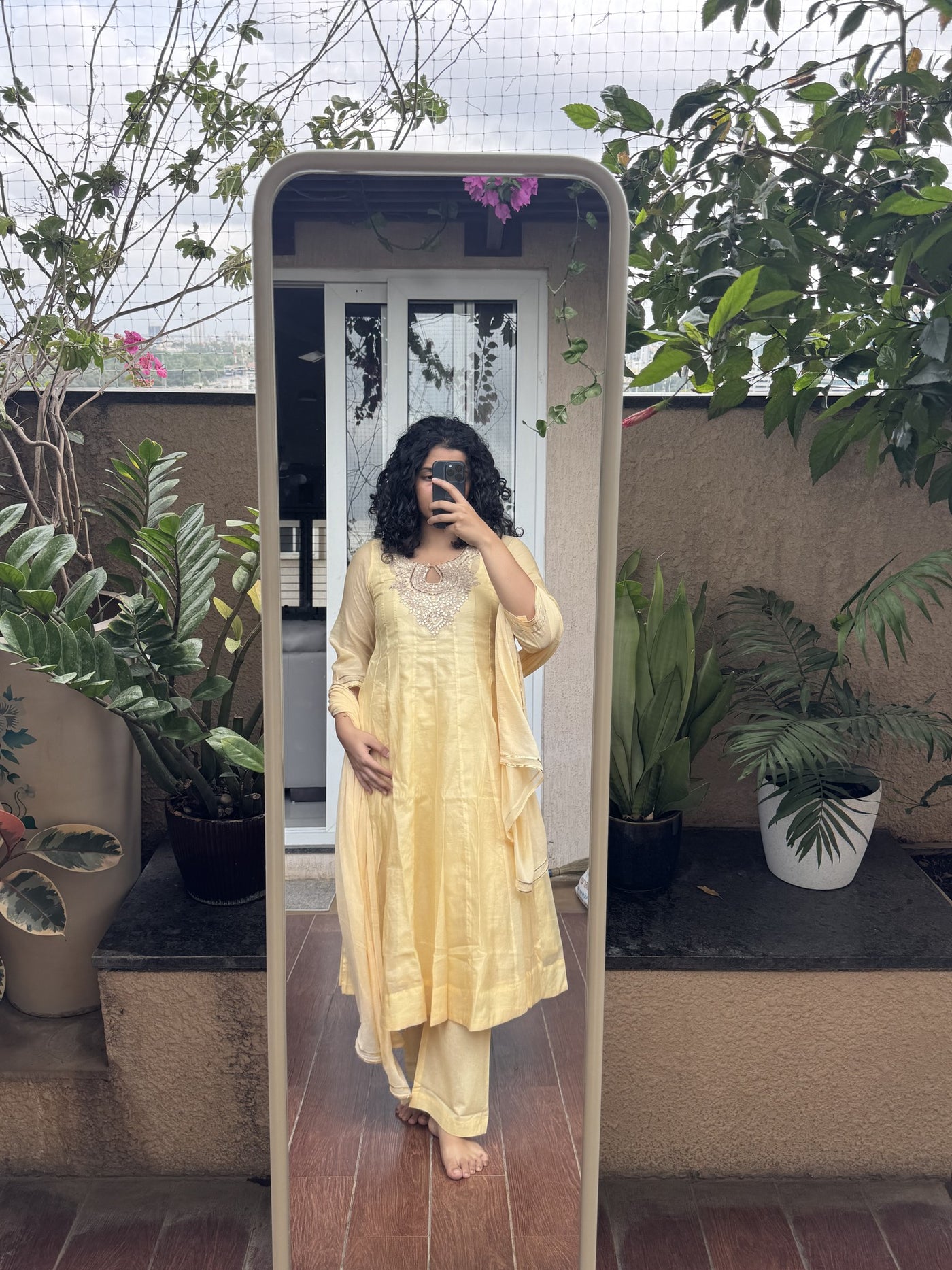 Saroj Jain Pastel Sunshine Yellow Lucknowi Chikankari Anarkali Gown front mirror view showing keyhole neckband and embroidered yoke.
